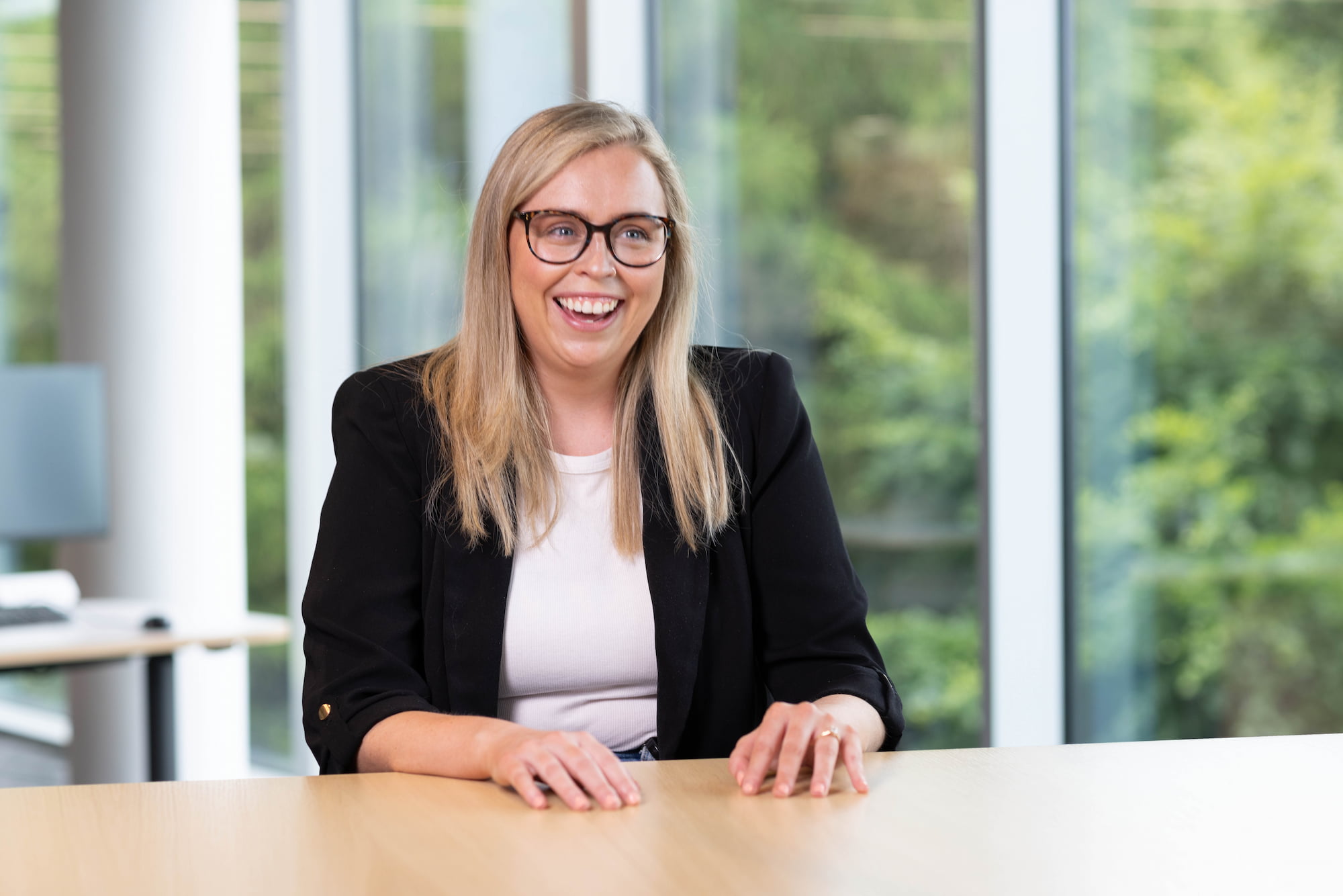 a person smiling at a table