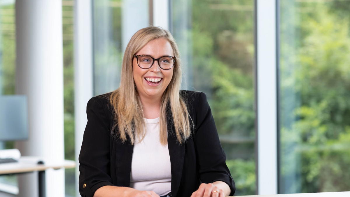 a person smiling at a table