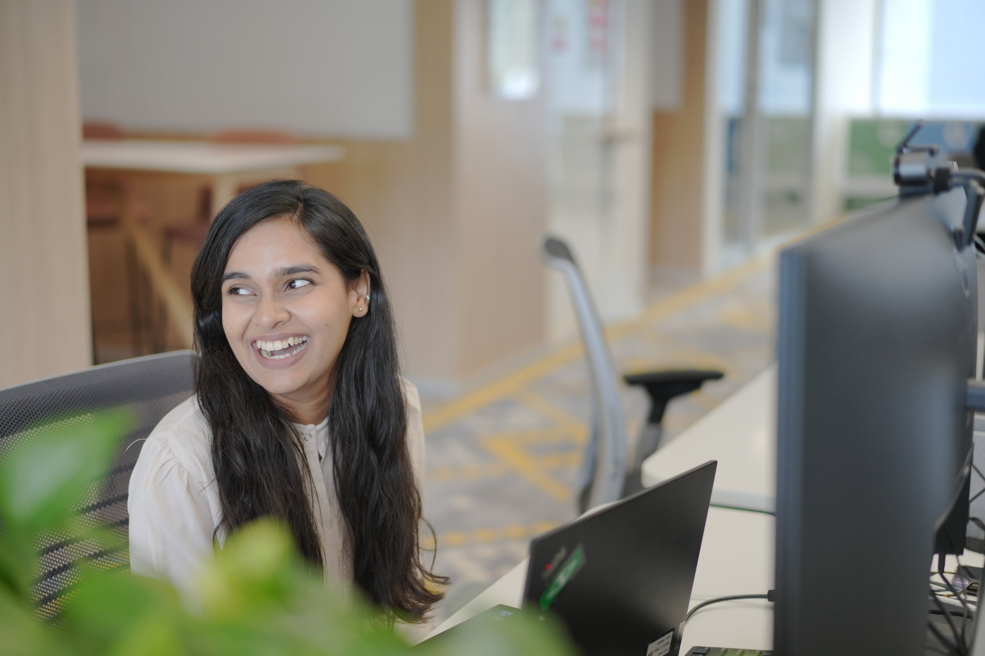 a person smiling at a computer