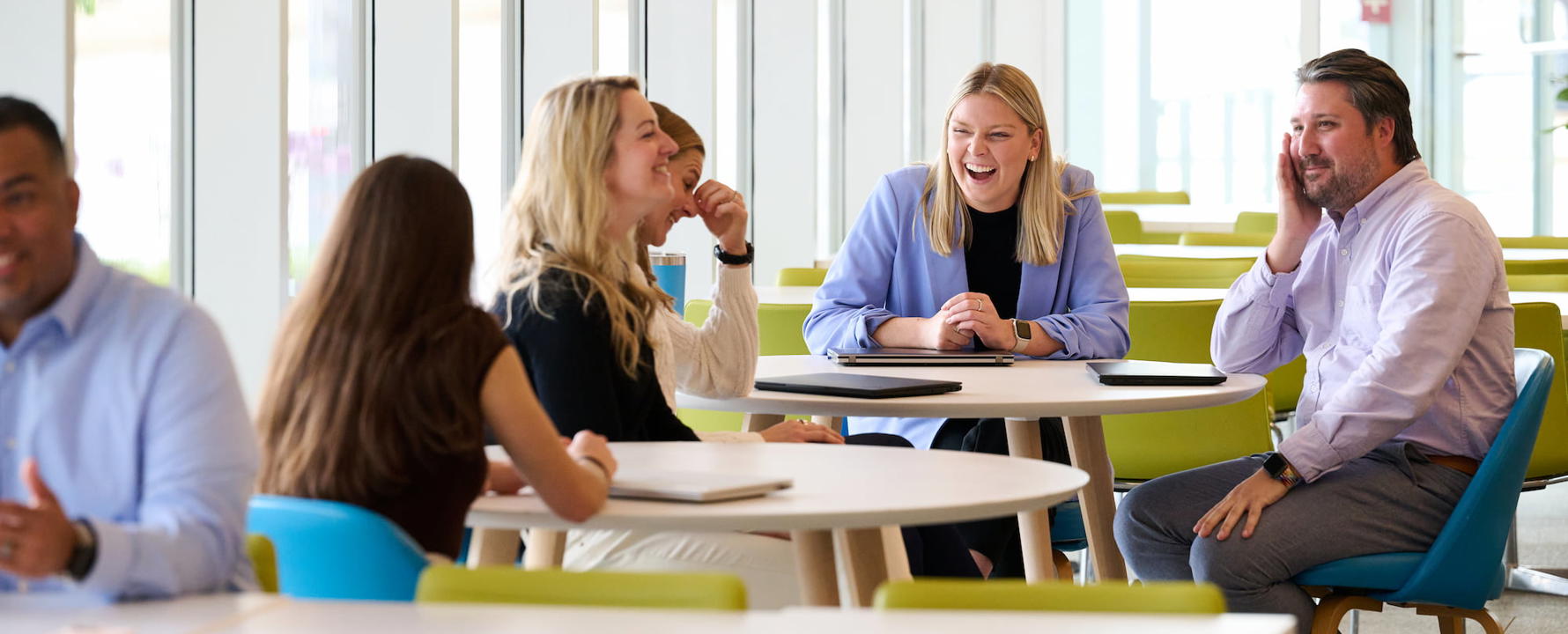 a group of people laughing at tables