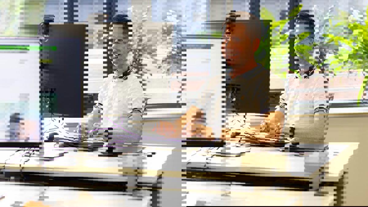 a person sitting at a desk with a computer