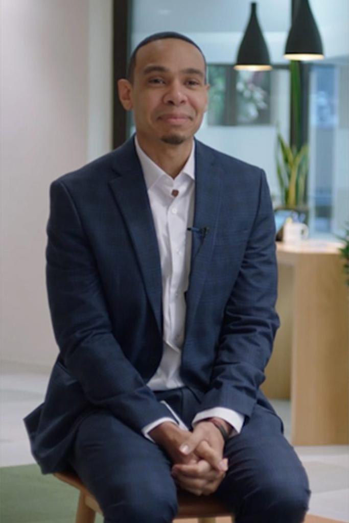 a person in a suit sitting on a chair