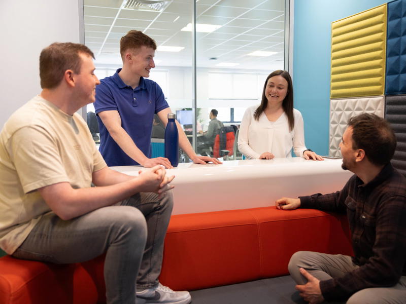 a group of people sitting around a counter