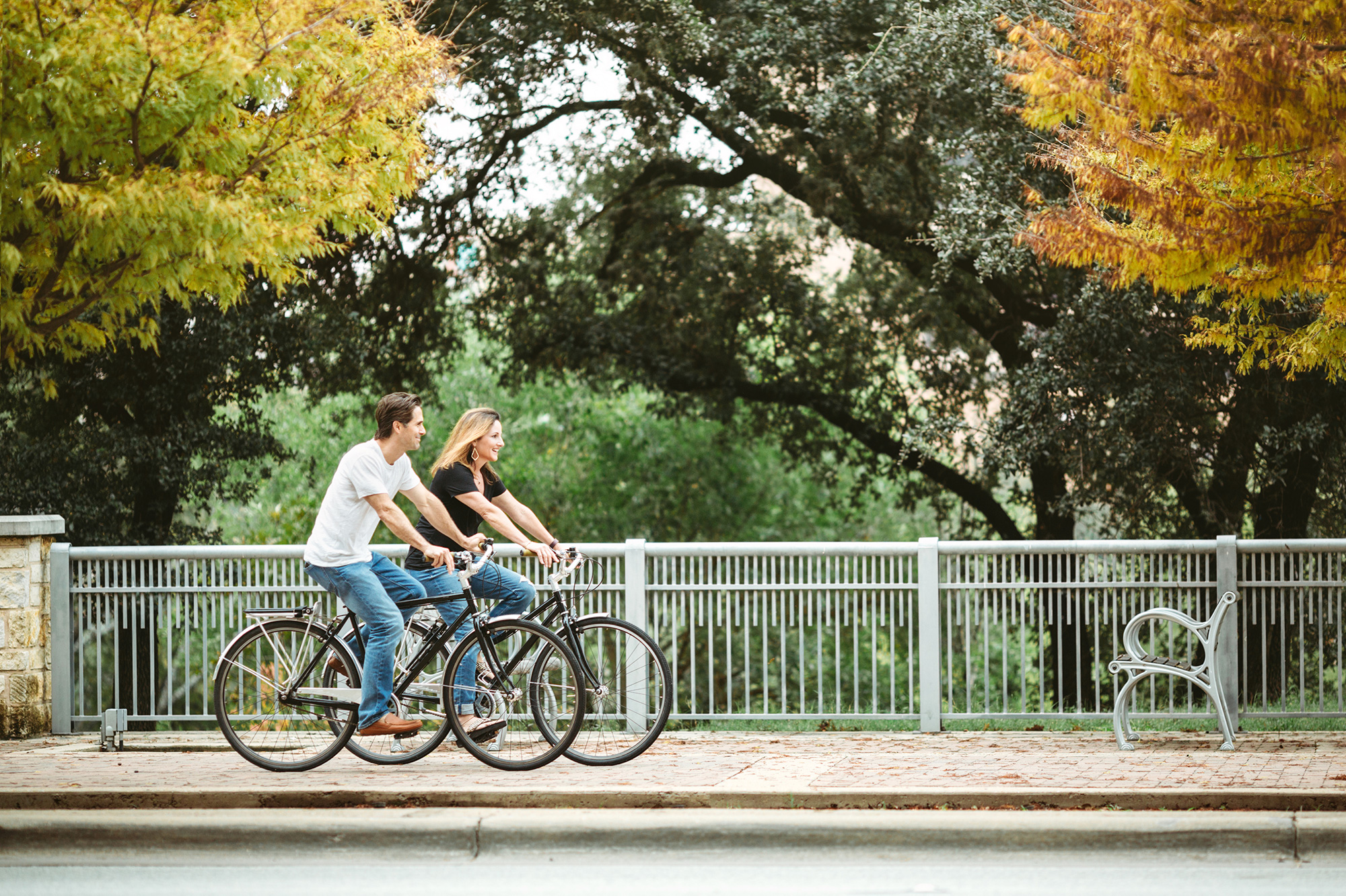 a person and person riding bicycles on a sidewalk