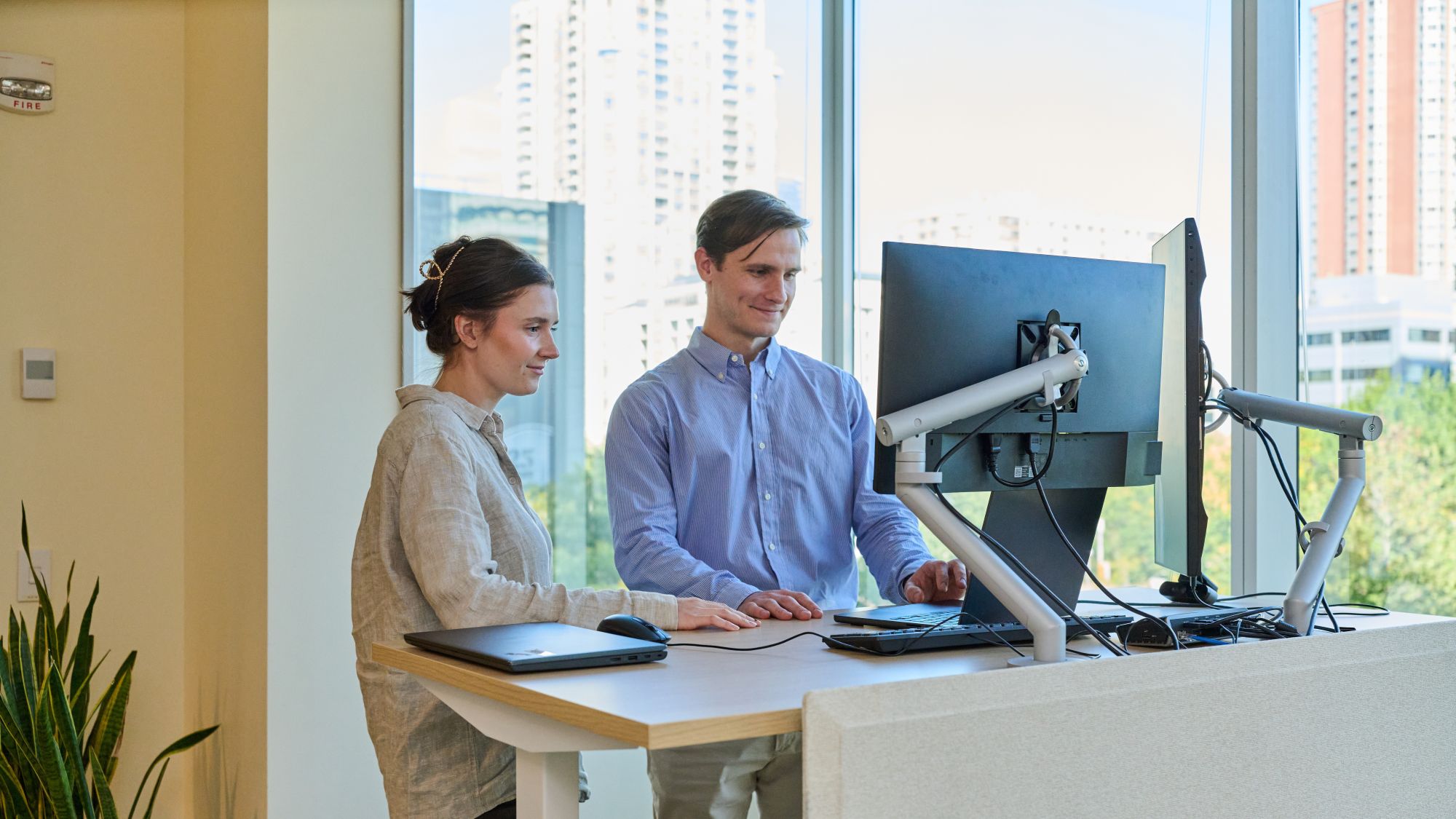 a person and person looking at a computer