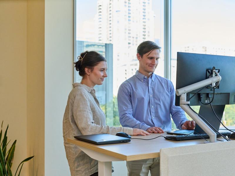 a person and person looking at a computer