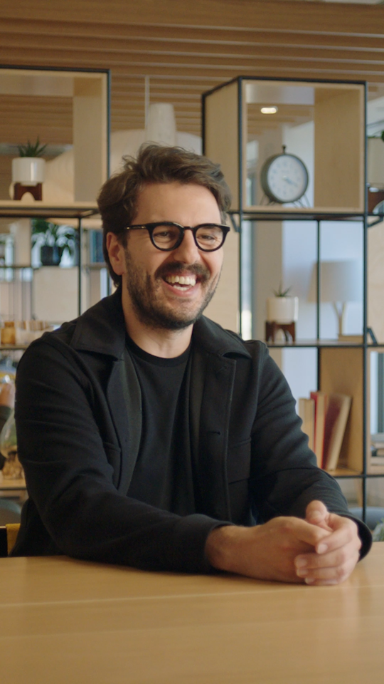 a person wearing glasses laughing