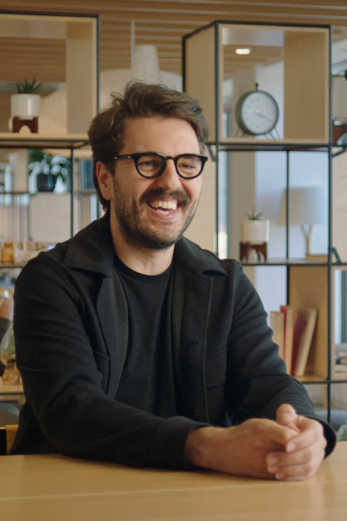 a person wearing glasses laughing