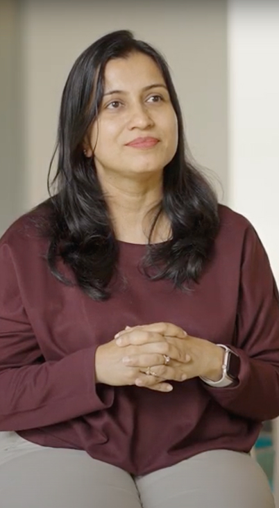 a person with long hair wearing a maroon shirt