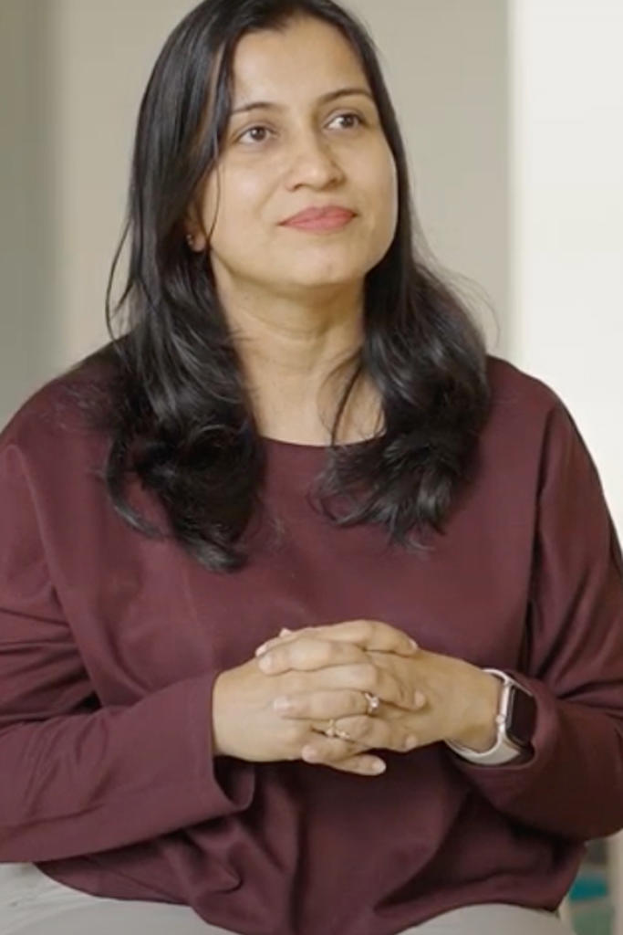 a person with long hair wearing a maroon shirt