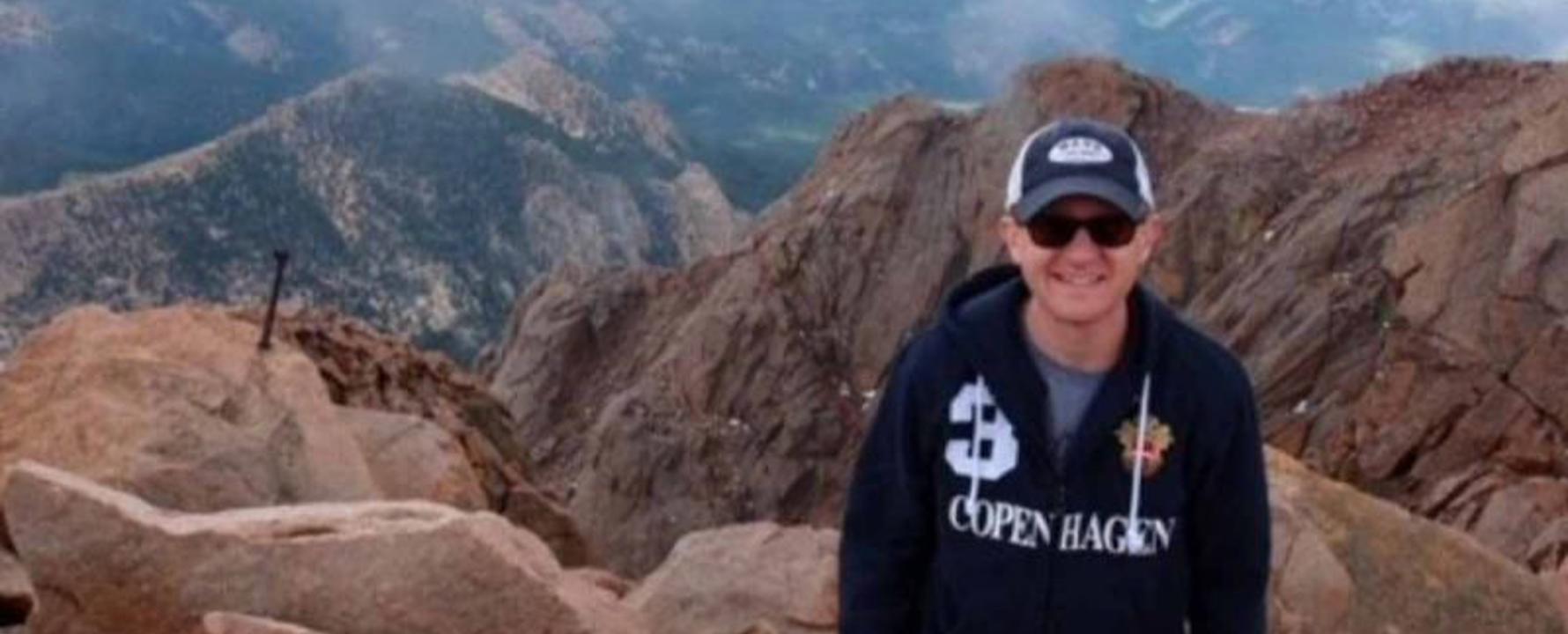 a person standing on a rocky mountain