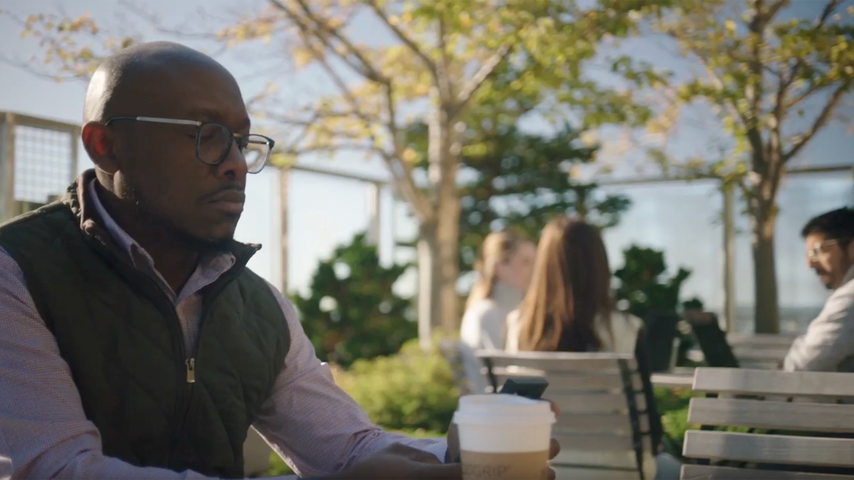 a person sitting at a table with a cup of coffee
