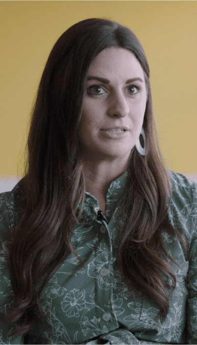 a person with long hair wearing a green shirt