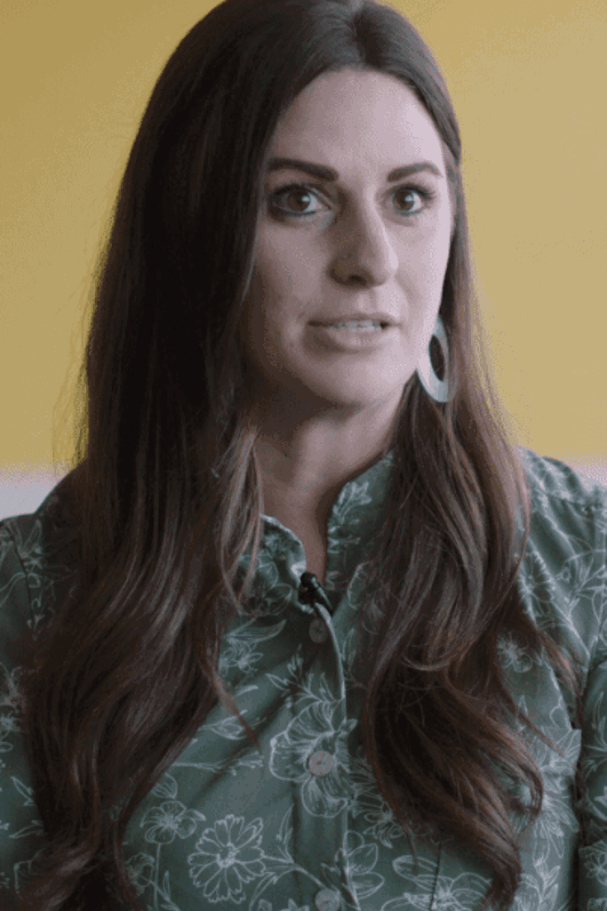 a person with long hair wearing a green shirt