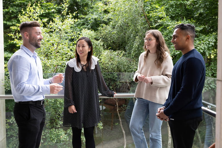 A group of employees chatting on an outdoor patio