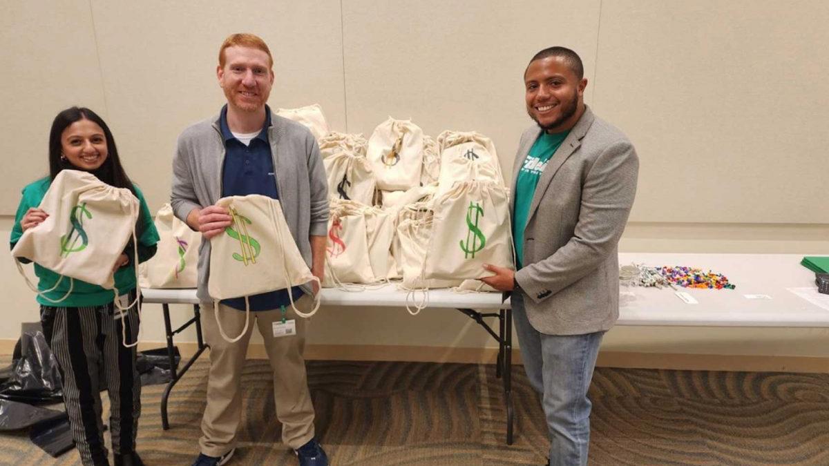 two men standing next to a table with bags
