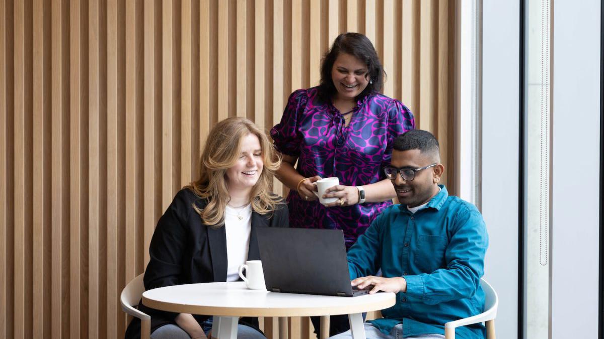 People Collaborating Smiling Laptop Coffee Office 1200X800