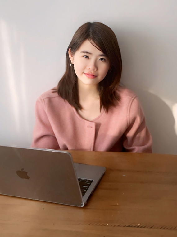 a person sitting at a table with a laptop