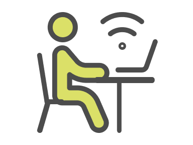 a person sitting at a desk with a laptop