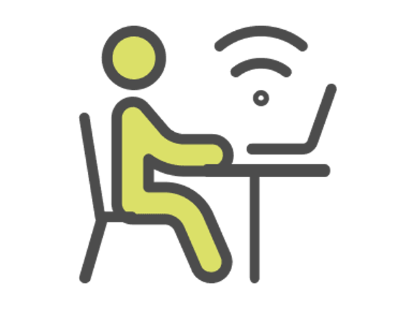 a person sitting at a desk with a laptop