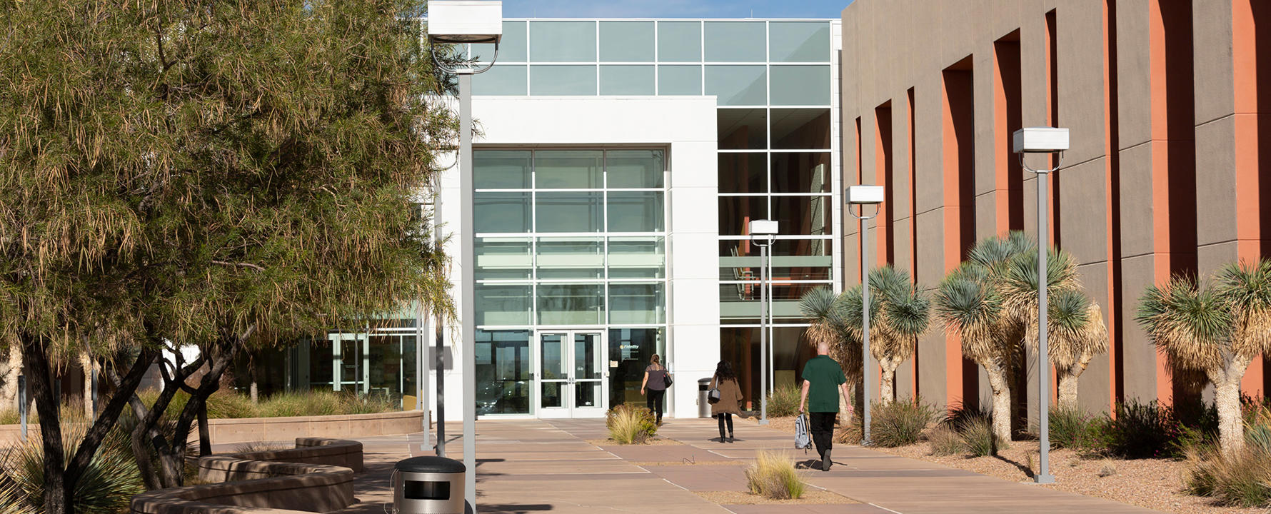a building with glass windows and trees