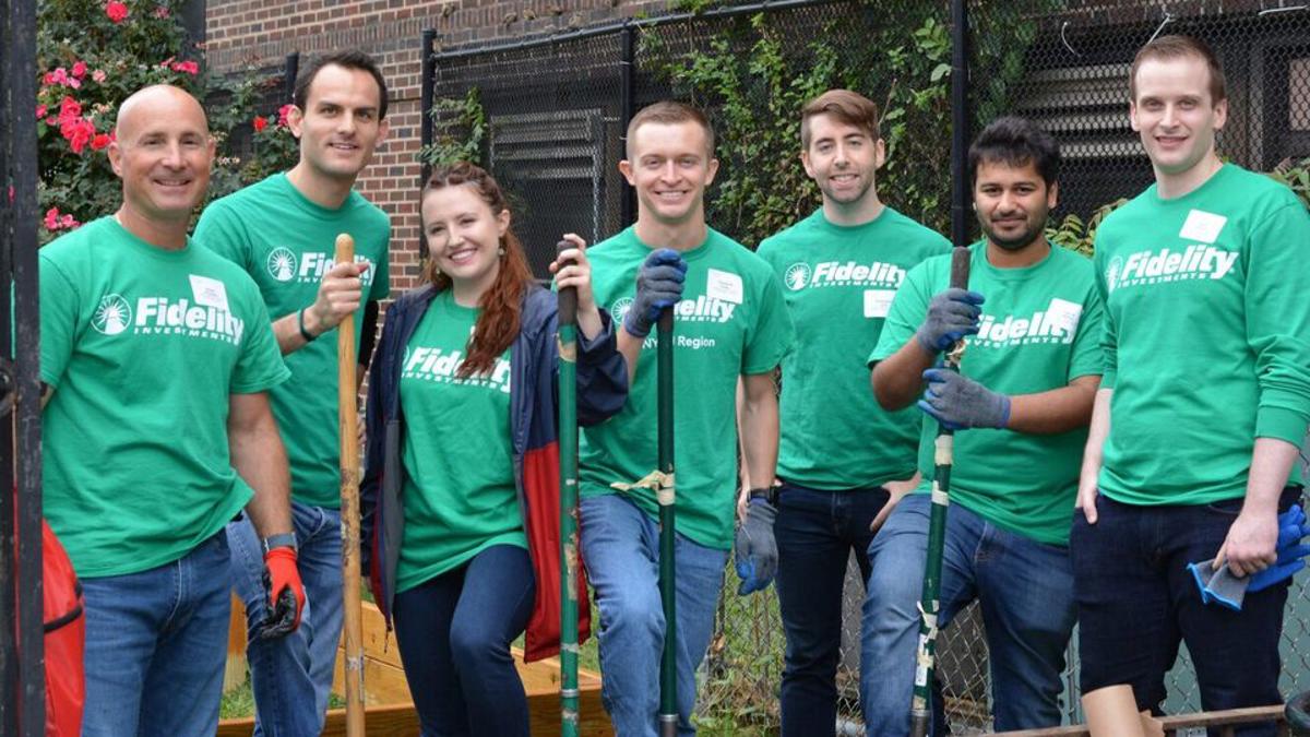a group of people in green t-shirts