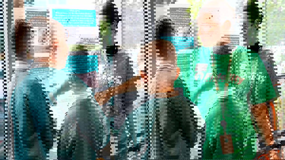 a person standing in front of a window with several children