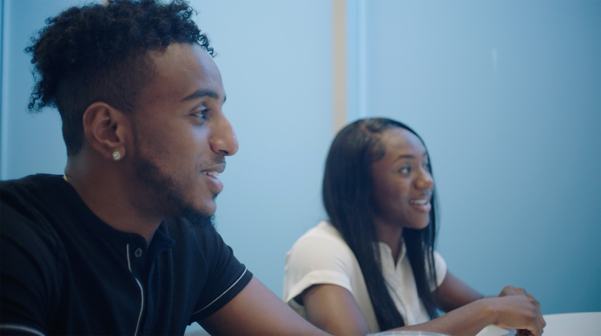 a person and person sitting at a table