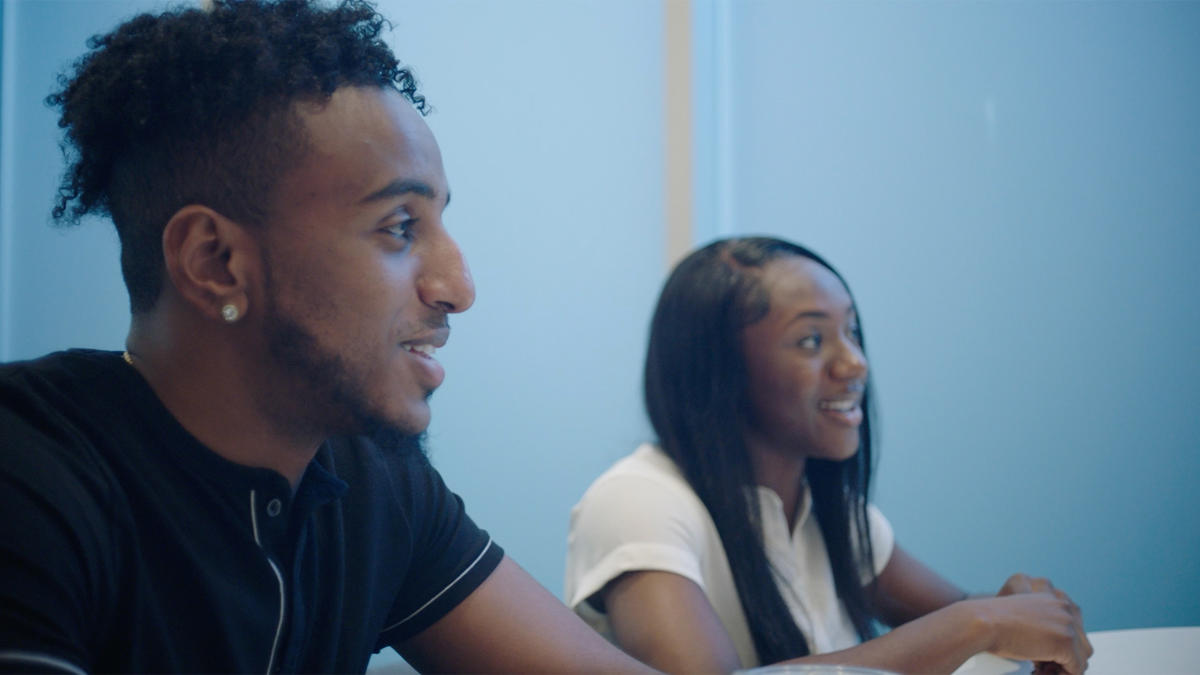 a person and person sitting at a table
