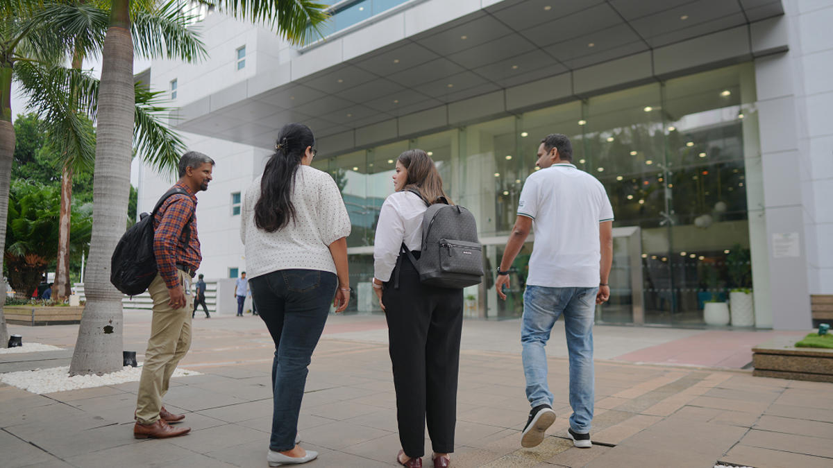 a group of people walking on a sidewalk