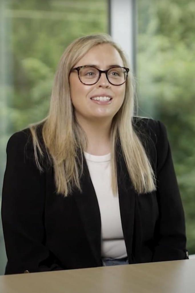 a person wearing glasses and a black jacket