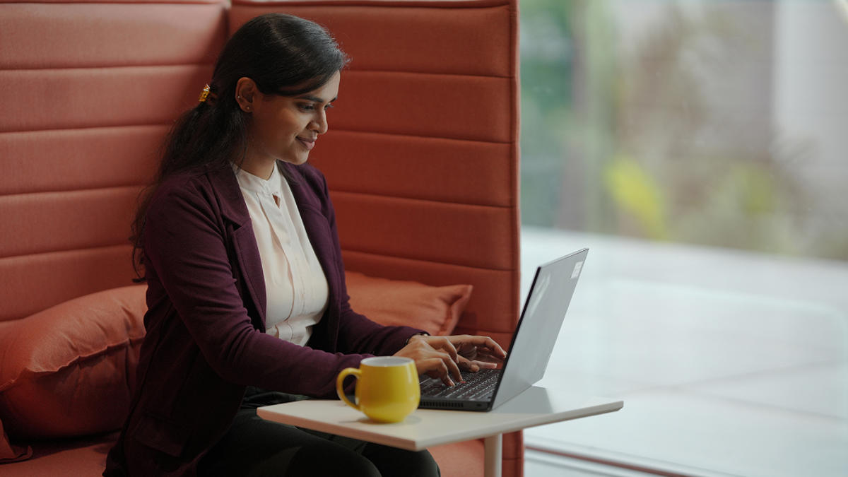 a person sitting at a table using a laptop