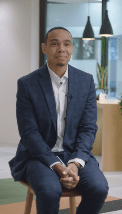 a person in a suit sitting in a chair