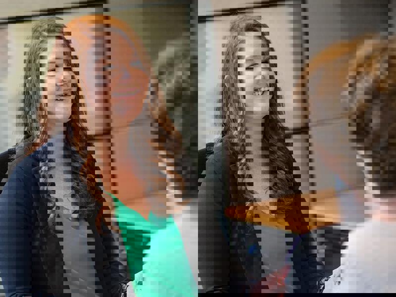 a person smiling and shaking hands with another person