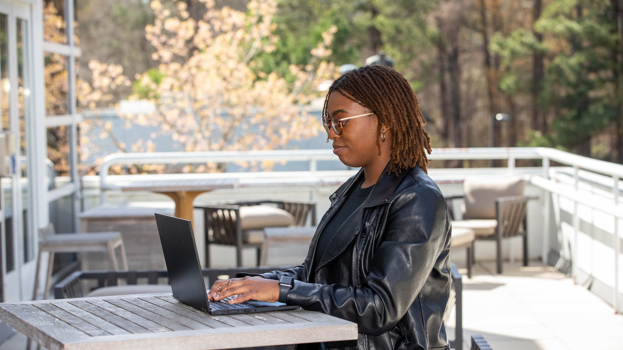a person sitting at a table with a laptop