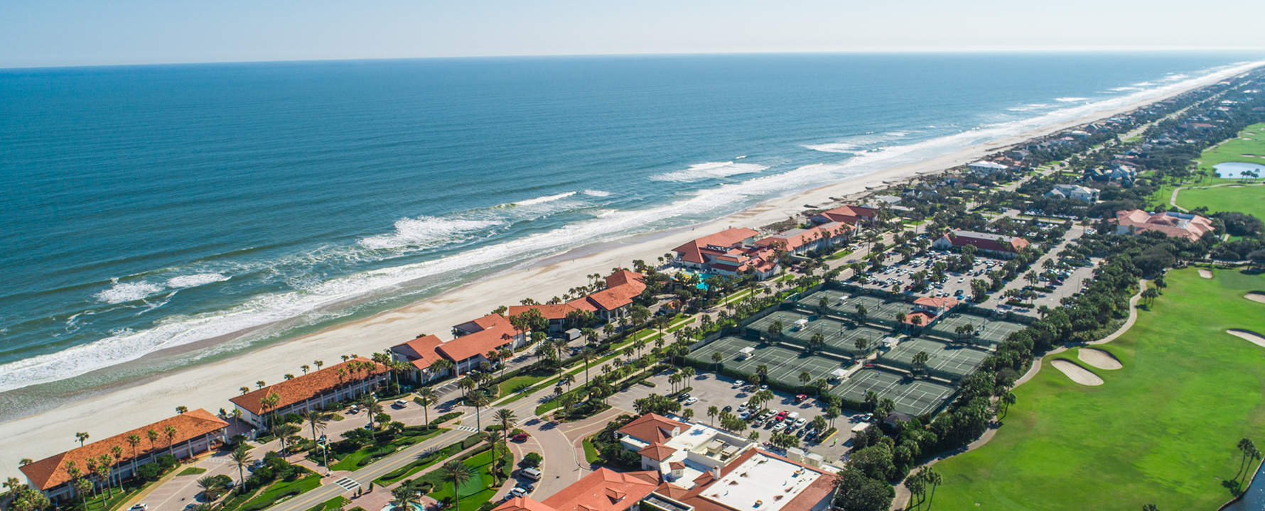 a beach with a lot of buildings and a body of water