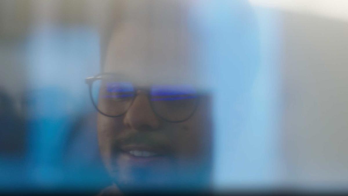 a person wearing glasses and smiling