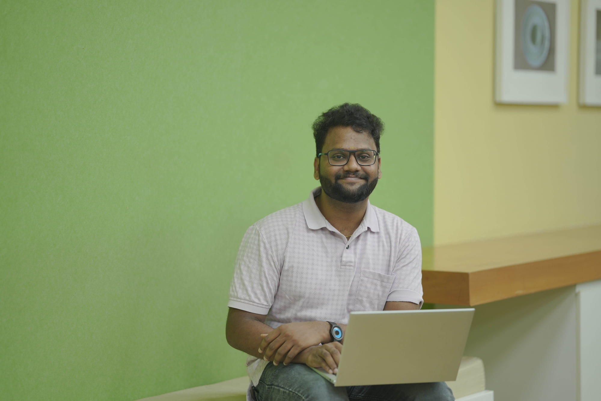 a person sitting on a bench with a laptop