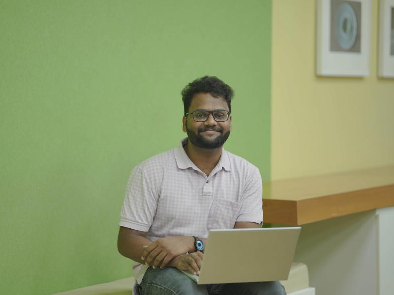 a person sitting on a bench with a laptop