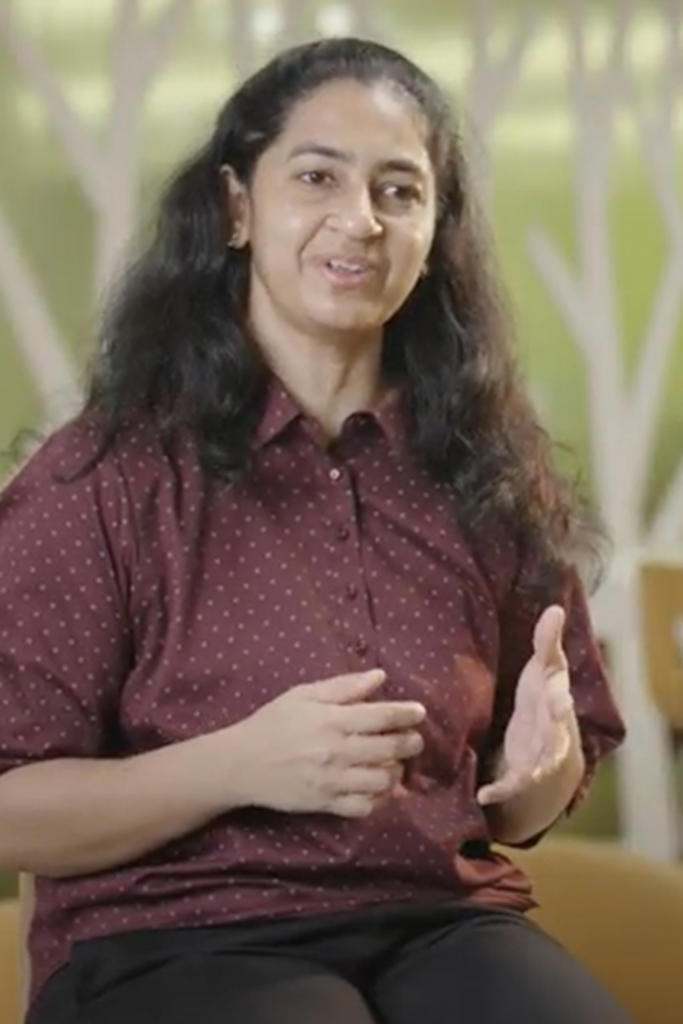 a person with long hair wearing a red shirt