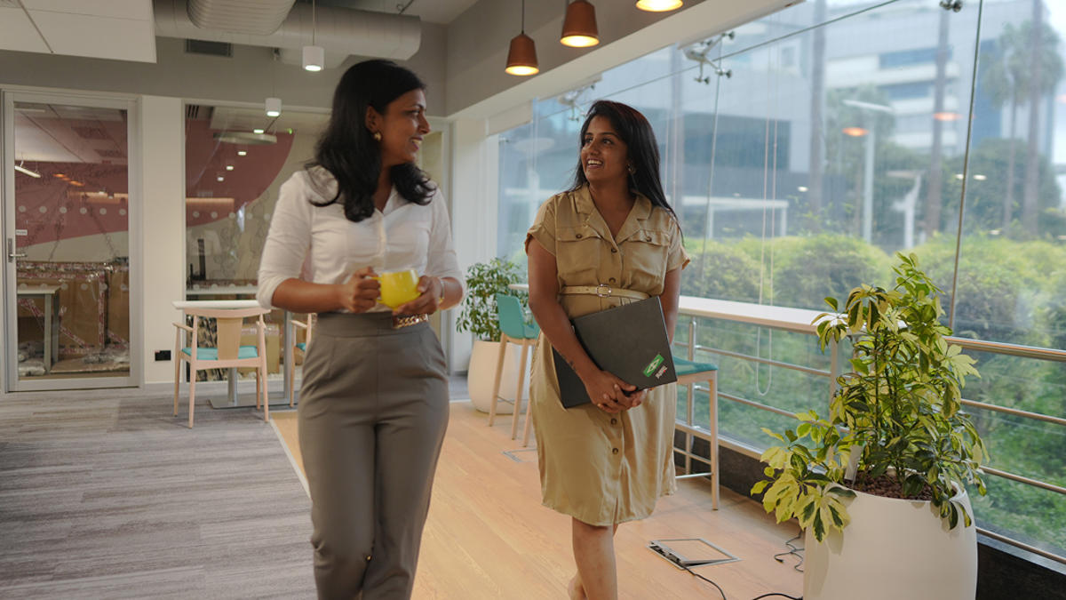two women walking in a room