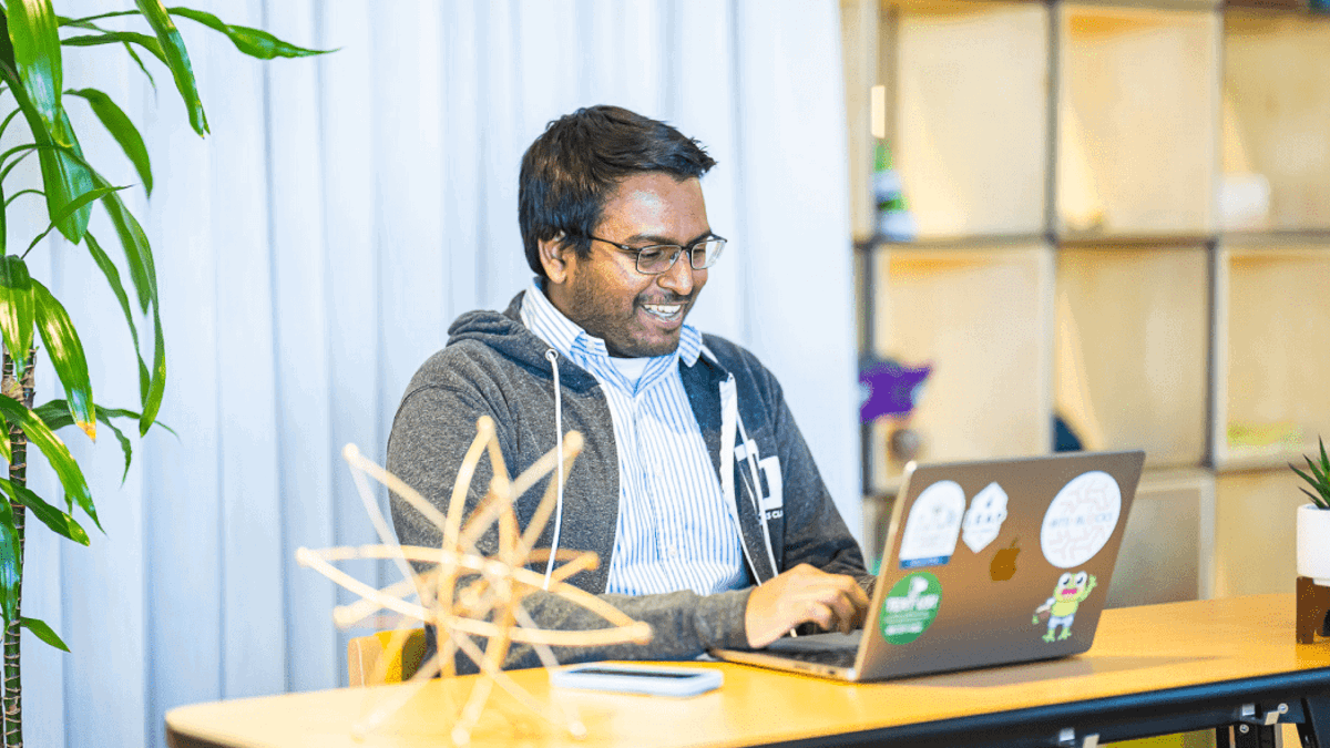 a person sitting at a desk with a laptop
