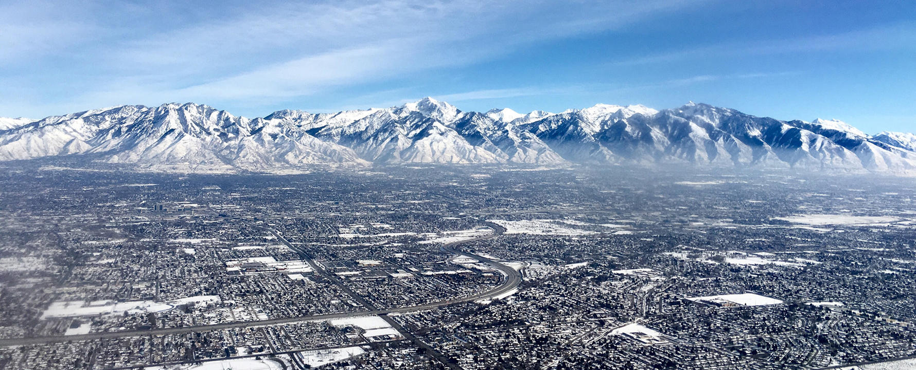 a city with snow covered mountains in the background