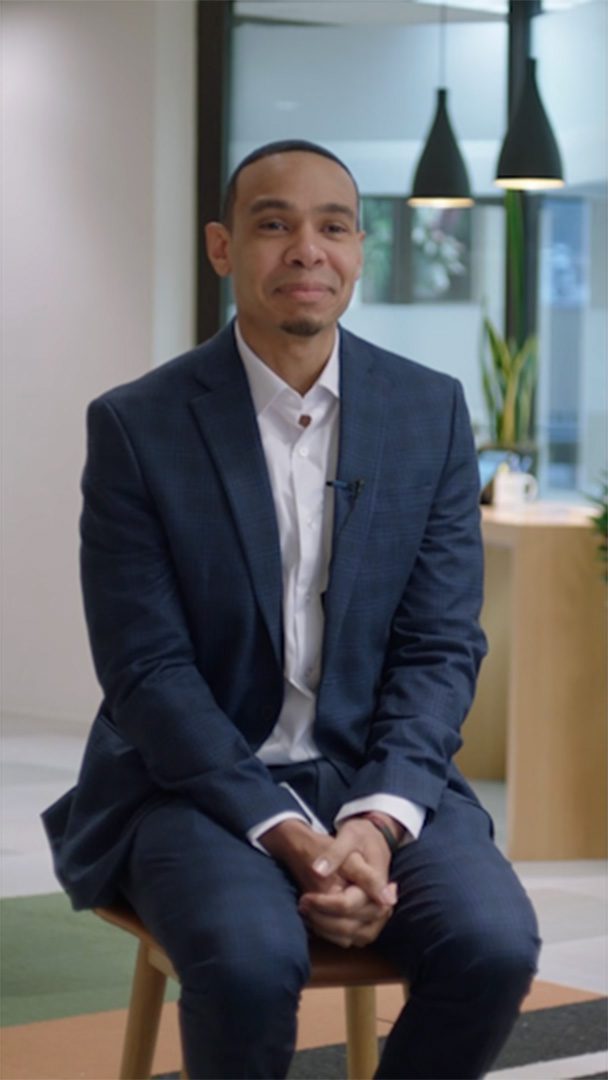 a person in a suit sitting on a chair