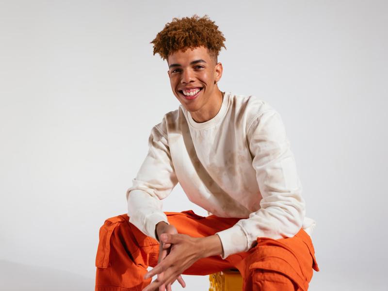 a person sitting on a yellow box