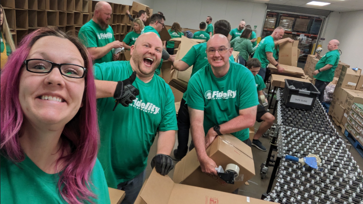 a group of people in green shirts