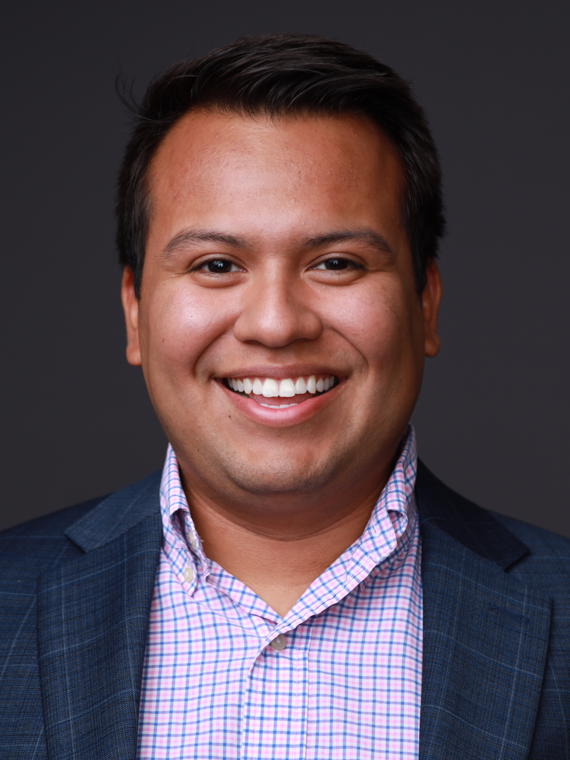 a person in a suit smiling