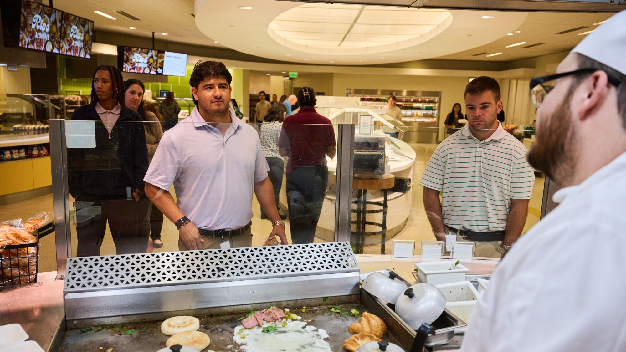 a group of people standing in a restaurant