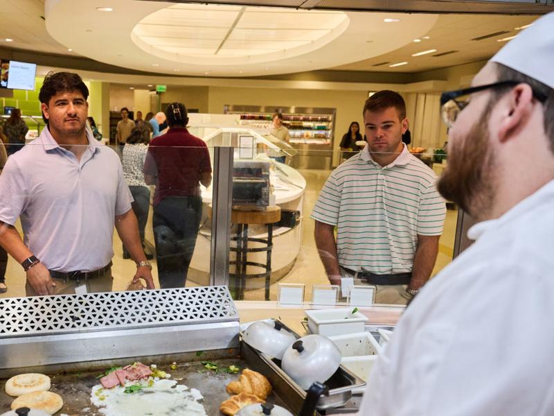 a group of people standing in a restaurant