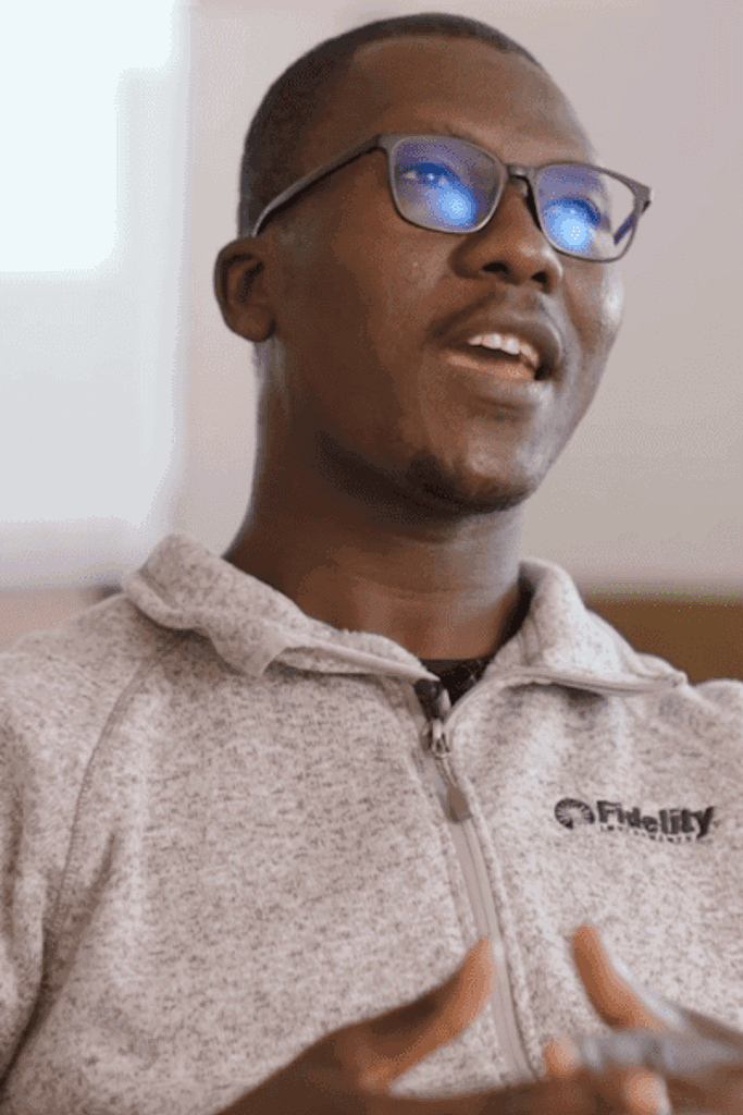 a person wearing glasses and a grey sweatshirt